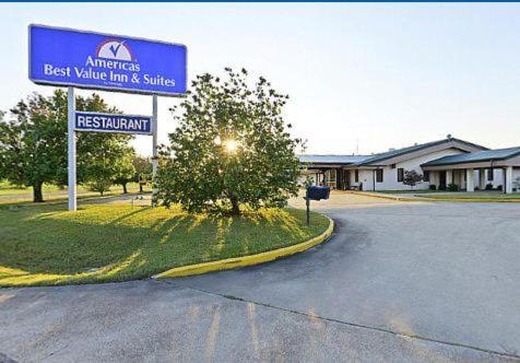 a sign for a best village inn and suites at America's Best Value Inn and Suites in Aberdeen