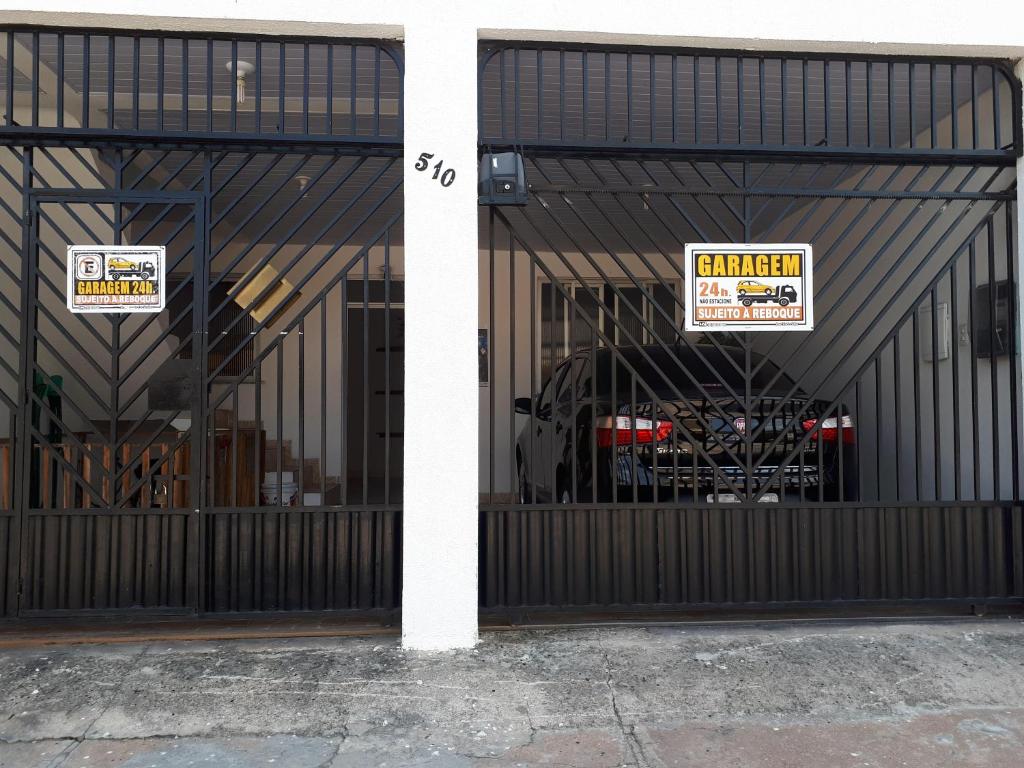 a garage with two signs on the doors of it at Casa para temporada in Belém