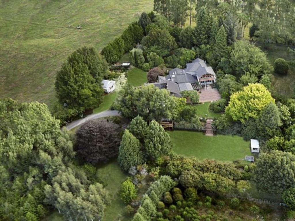 an aerial view of a large house in the trees at Centennial House Taupo in Taupo