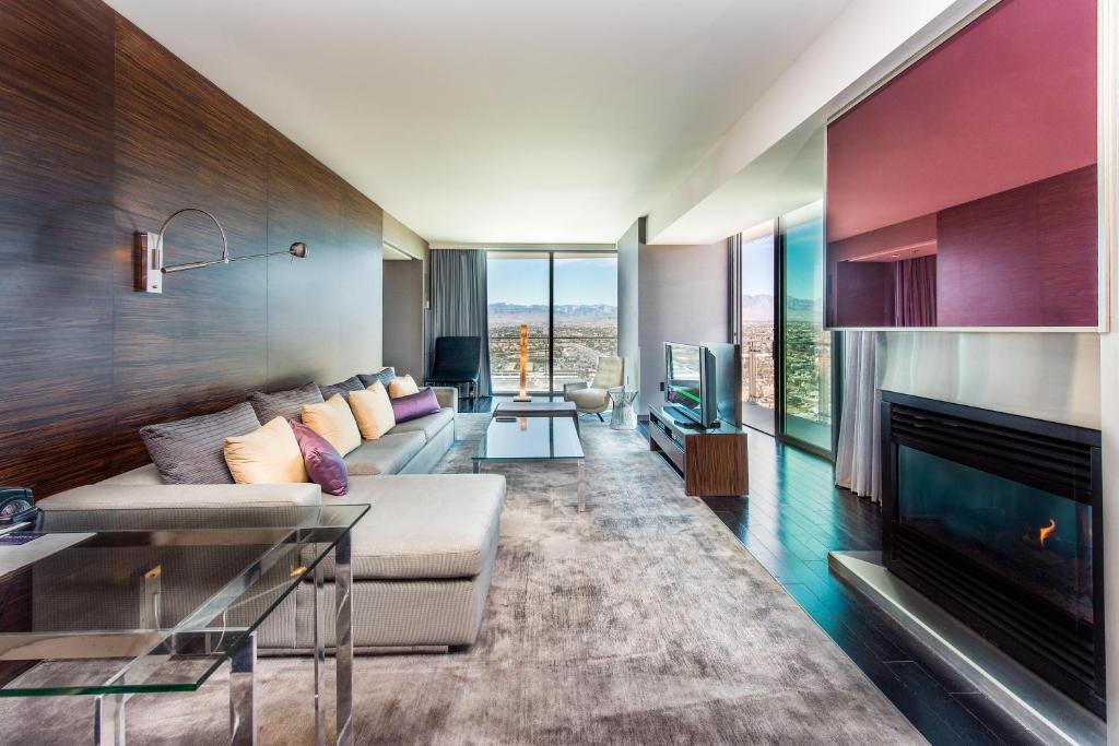 a living room with a couch and a fireplace at Palms Place One Bedroom Suite 1220 sqft in Las Vegas