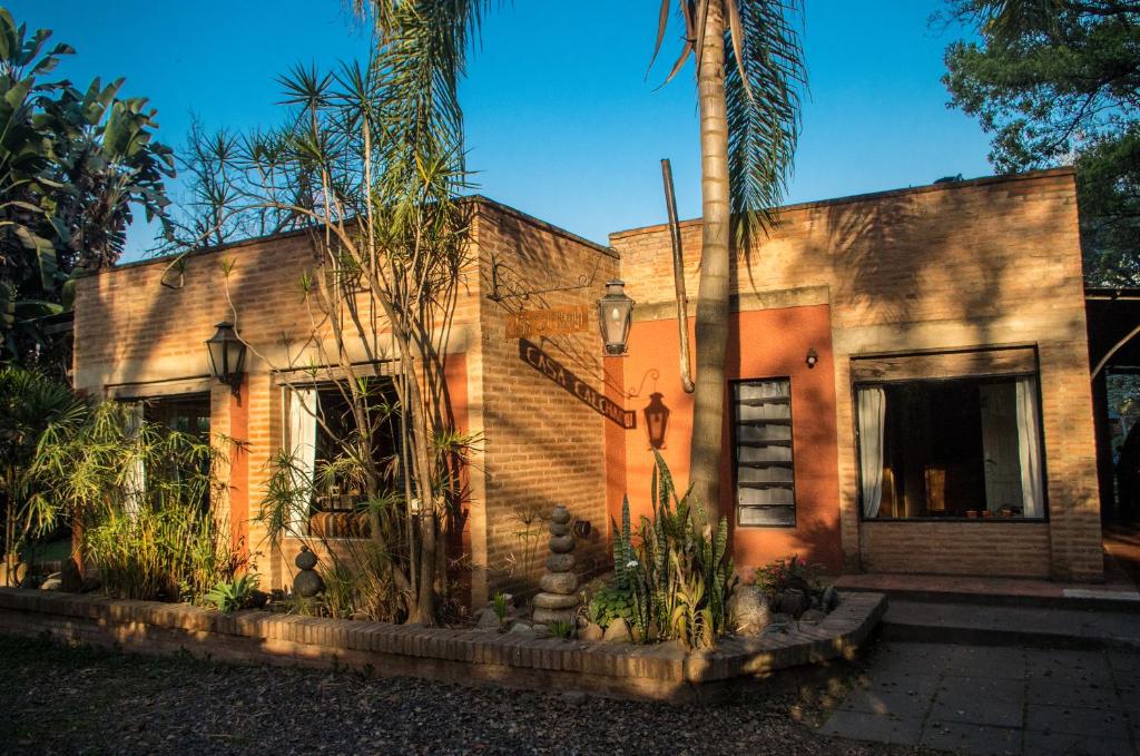 a house with a palm tree in front of it at Casa Calchaqui in Yerba Buena