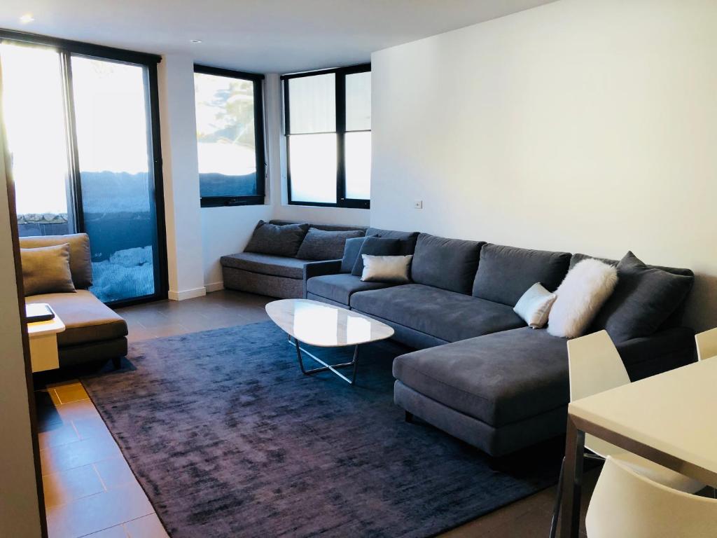 a living room with a couch and a table at East 302 St Falls in Falls Creek