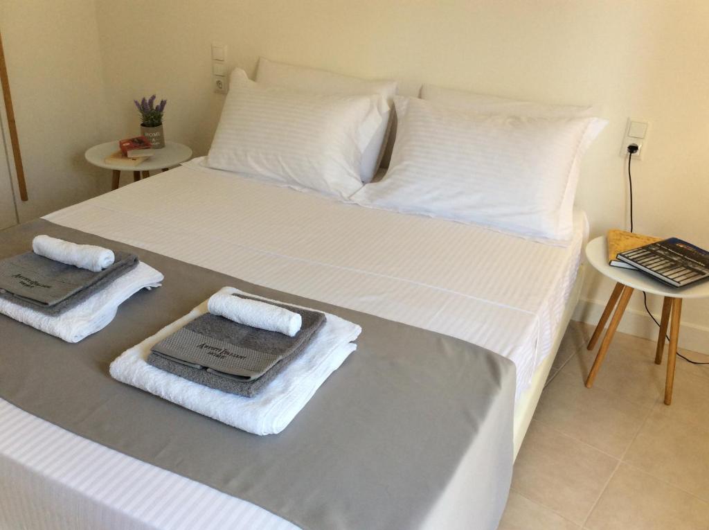 a bedroom with two beds with towels on them at Heraklion City Center Apartment in Heraklio Town