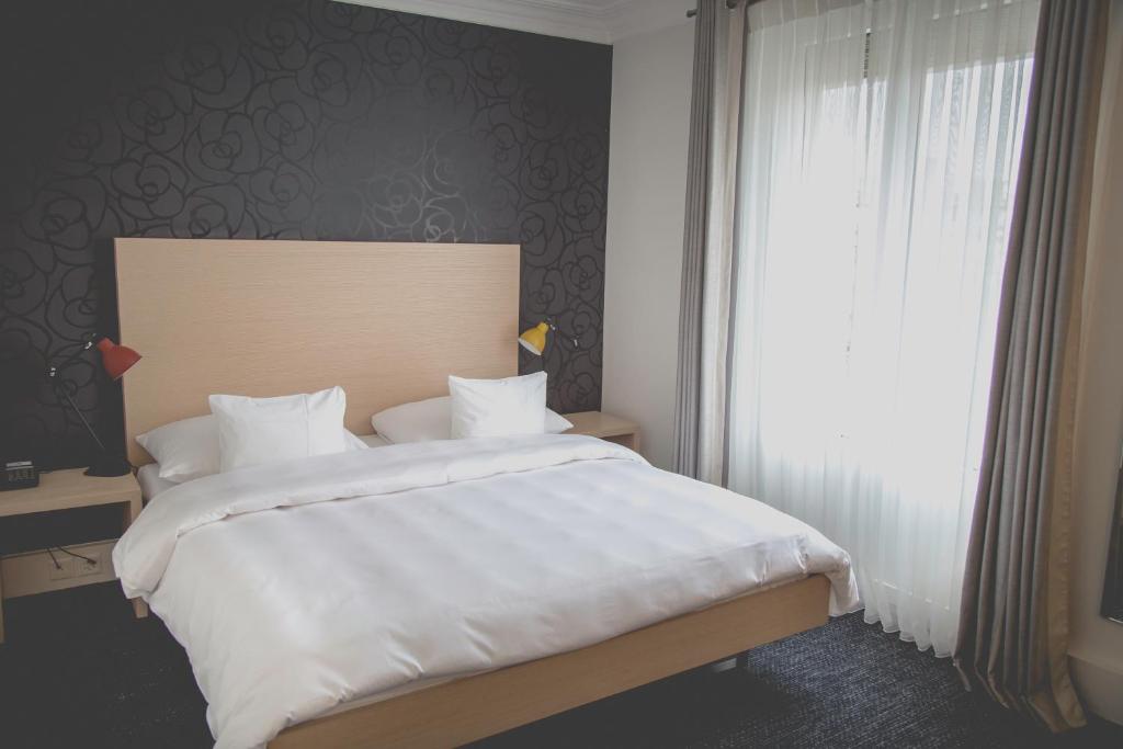Postel nebo postele na pokoji v ubytování Hotel Mon Repos