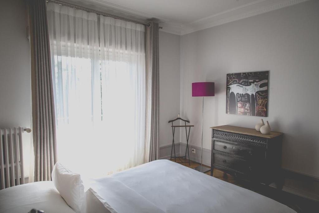Postel nebo postele na pokoji v ubytování Hotel Mon Repos