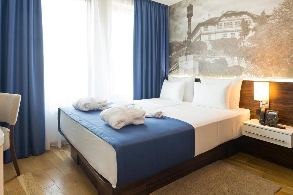 Postel nebo postele na pokoji v ubytování Abba Hotel