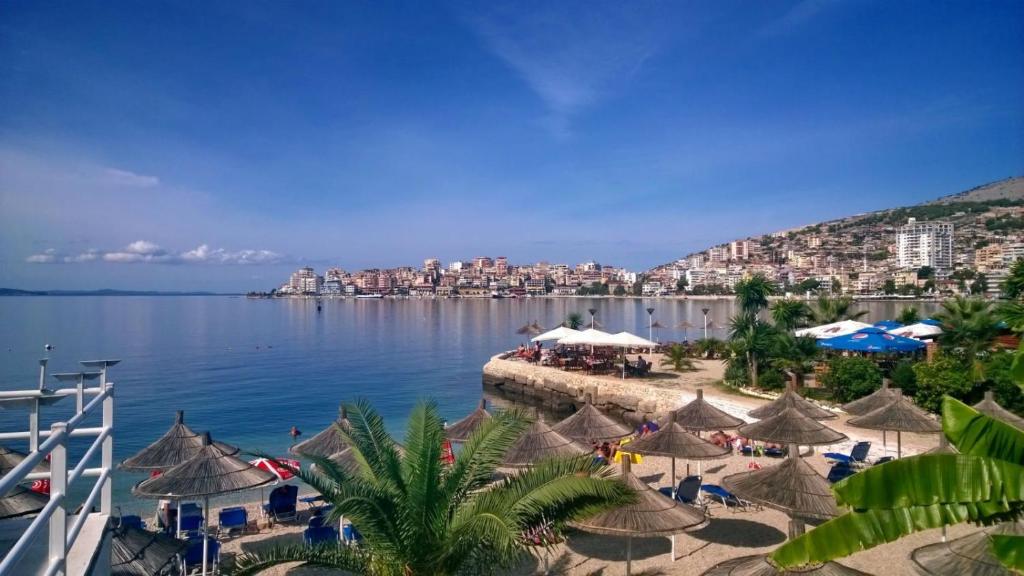a view of a beach with umbrellas and the water at Apartment in Sarande in Sarandë