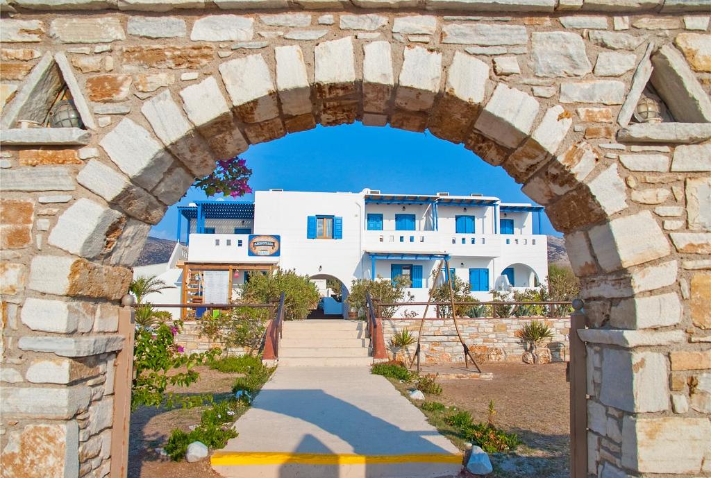 an archway over a path in front of a building at Ammoudia Studios in Agiassos