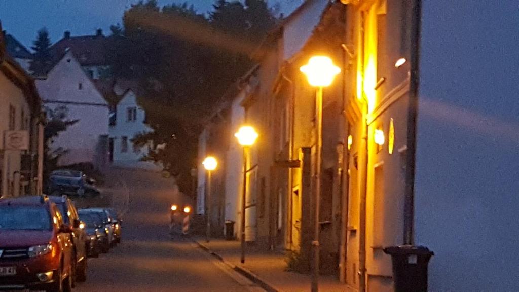 eine Straße in der Nacht mit Lichtern an der Seite eines Gebäudes in der Unterkunft Apartment Lutherrose in Lutherstadt Eisleben