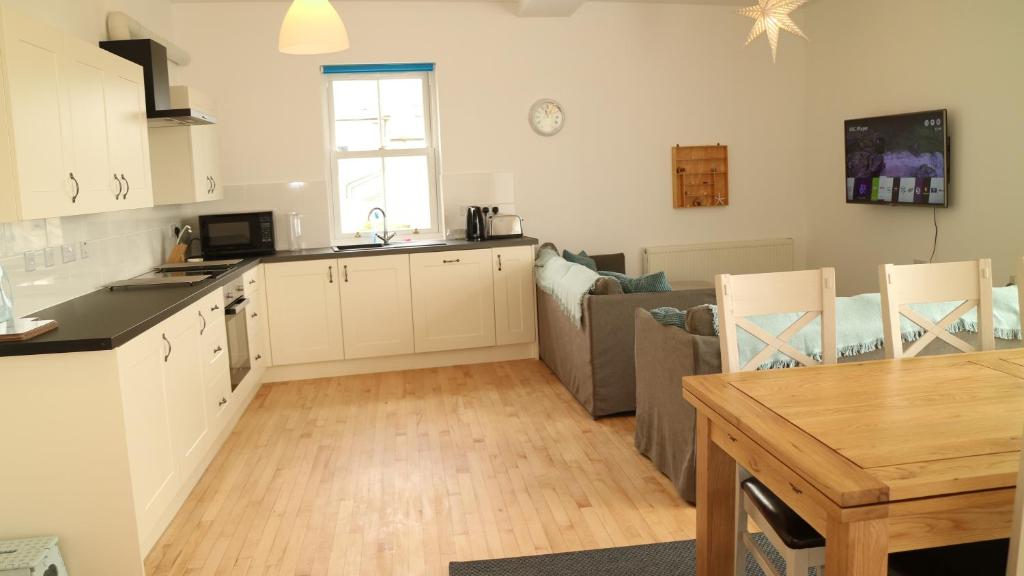 a kitchen and living room with a couch and a table at The Old Legion in Eyemouth