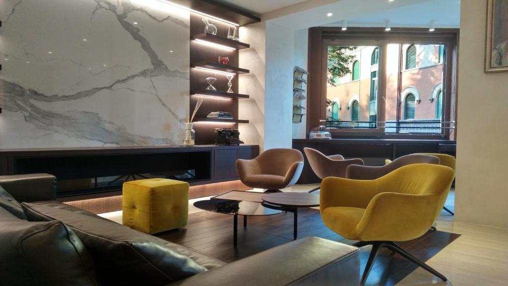 a lobby with a couch and chairs and a fireplace at Hotel Federale in Lugano