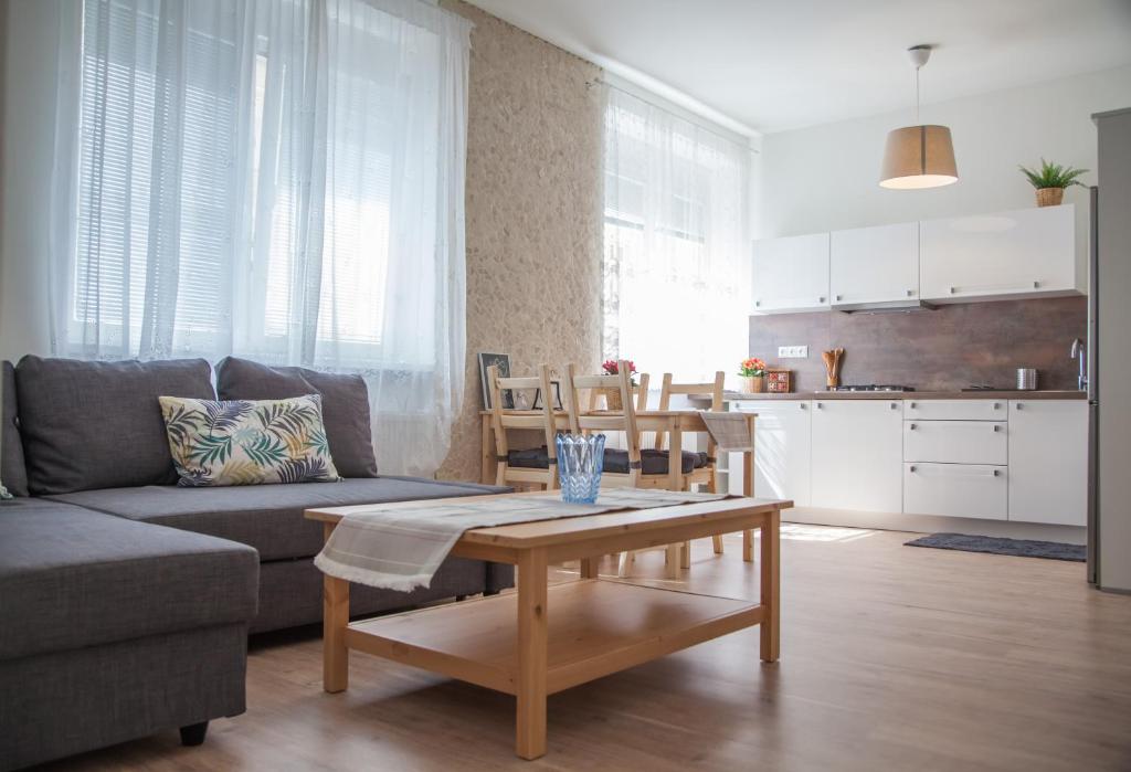 a living room with a couch and a table at Downtown pedestrian zone apartment in Bratislava