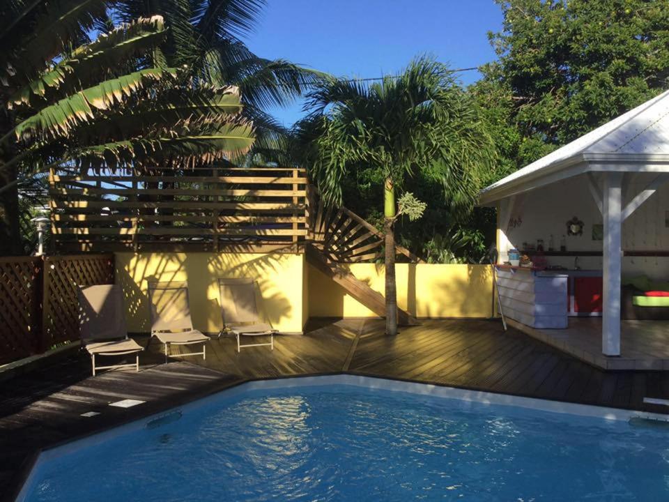una piscina en un patio con una casa en ti case gwada location en Sainte-Anne
