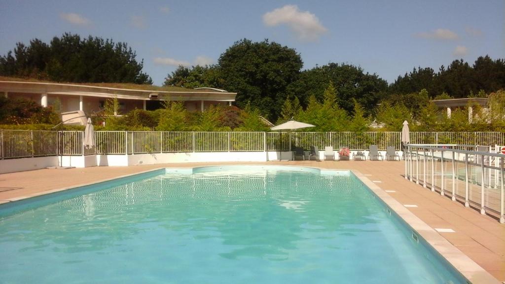 una gran piscina con una valla alrededor en Saint Denac - Golf de la Baule en Saint-André-des-Eaux
