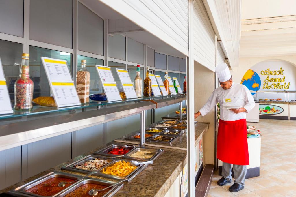 a chef standing in front of a buffet of food at TUI MAGIC LIFE Penelope Beach - Families & Couples in Midoun