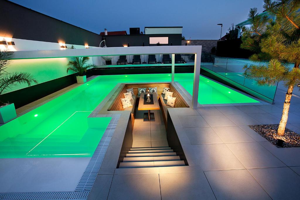 a house with a swimming pool at night at Apartmány Ladná in Ladná