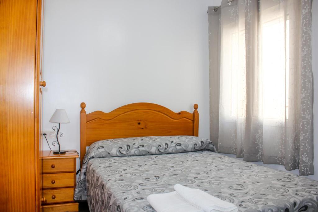Posteľ alebo postele v izbe v ubytovaní Apartamentos El Galán II