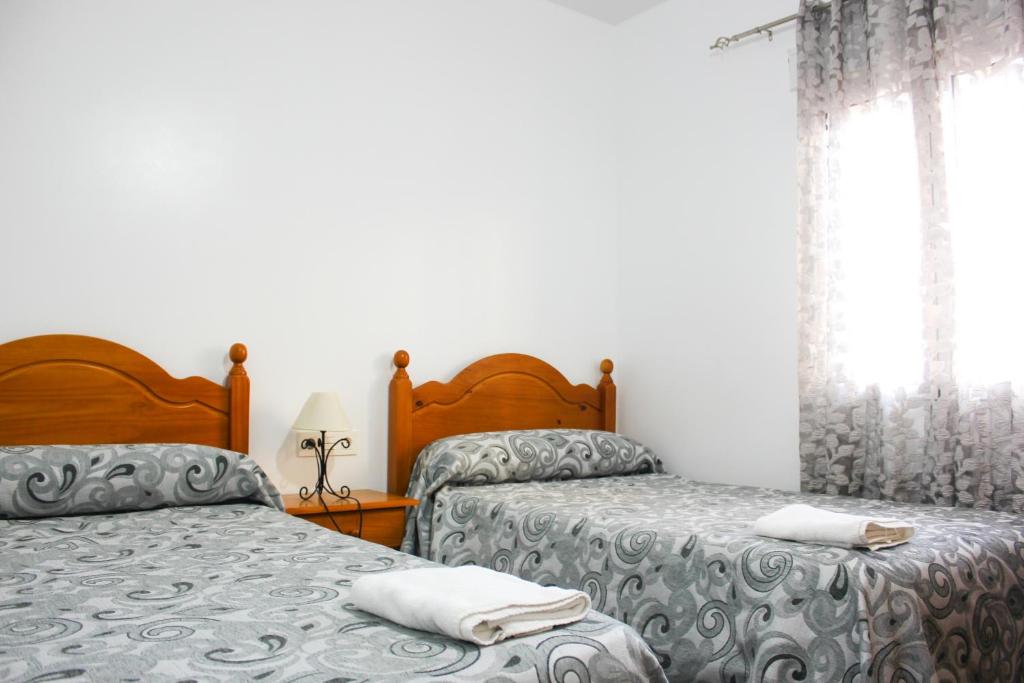 Posteľ alebo postele v izbe v ubytovaní Apartamentos El Galán II