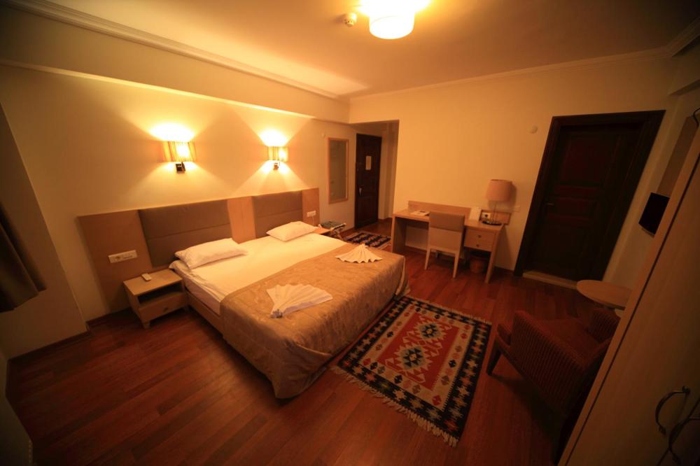 Postel nebo postele na pokoji v ubytování Iksir Resort Town
