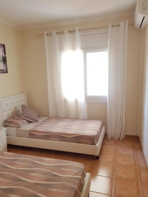Postel nebo postele na pokoji v ubytování Apt a Calafell plage