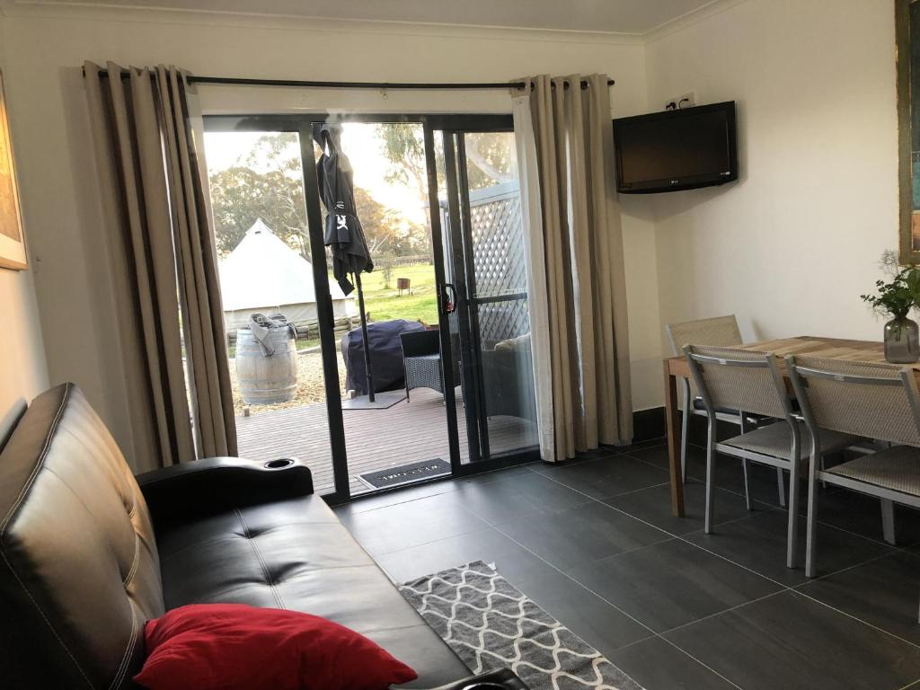 a living room with a couch and a table at Coonawarra Ensuite Unit B in Coonawarra