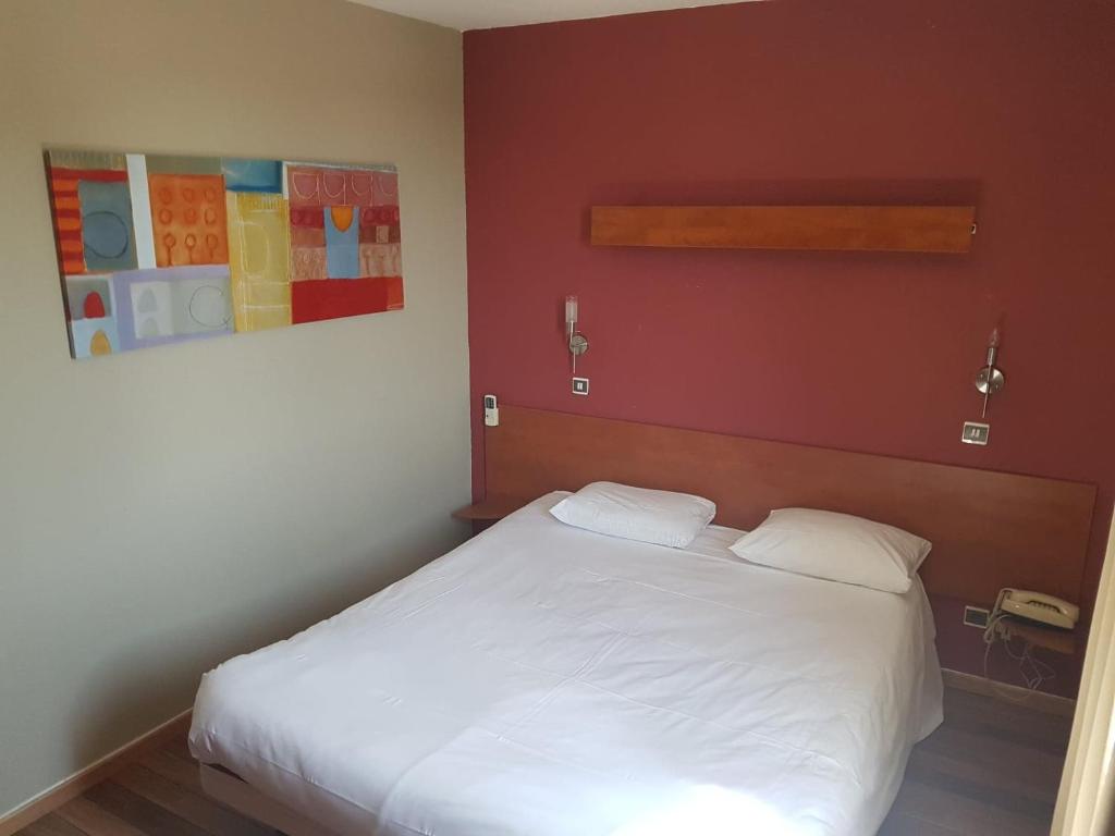 Postel nebo postele na pokoji v ubytování Hôtel Point Bleu