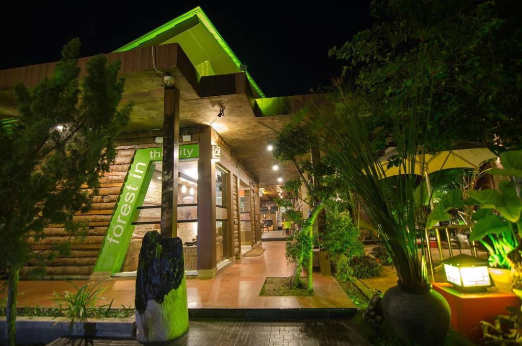 a store with a green sign on the front of it at Lawaka Hotel in Ampana