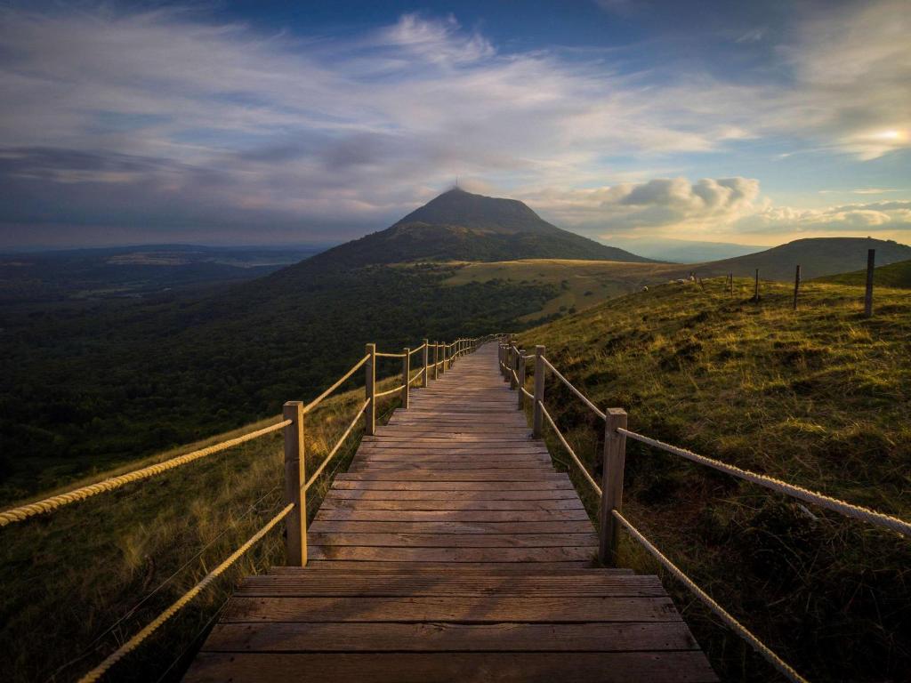 a wooden boardwalk leading up to a mountain at hotelF1 Clermont Ferrand Est in Clermont-Ferrand