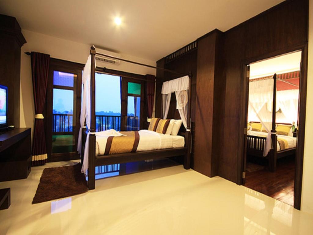 Postel nebo postele na pokoji v ubytování Dee Andaman Hotel