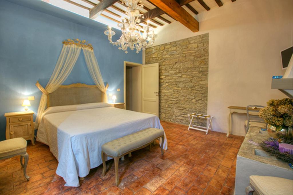 1 dormitorio con cama y pared de piedra en Corte San Ruffillo Country Resort, en Dovadola