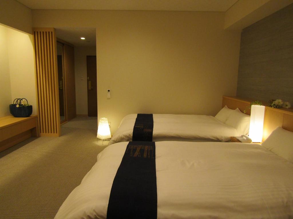 Postel nebo postele na pokoji v ubytování Japanese Style Hotel Isomura