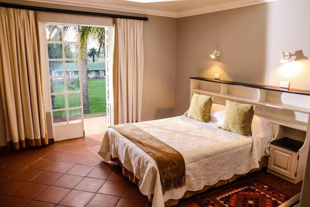 A bed or beds in a room at Newcastle Country Lodge