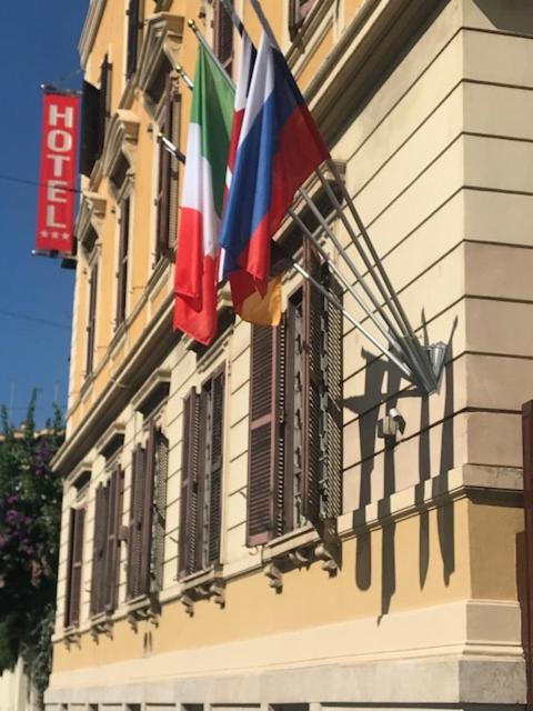 two flags on the side of a building at Roma Room Hotel in Rome