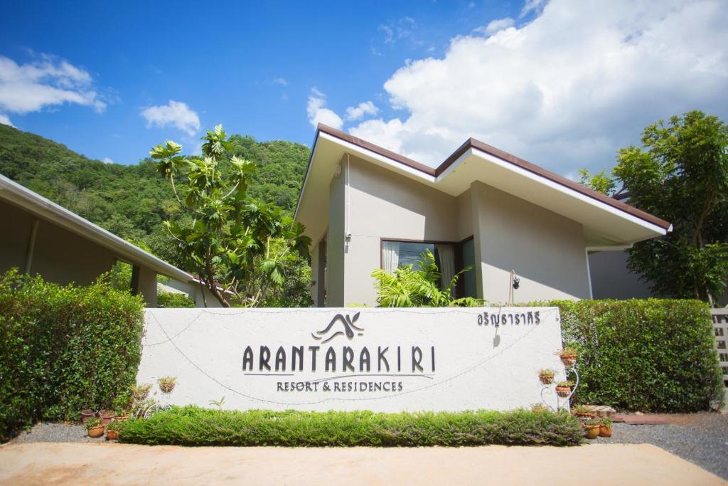 a house with a sign in front of it at Arantarakiri Resort Khao Yai in Mu Si