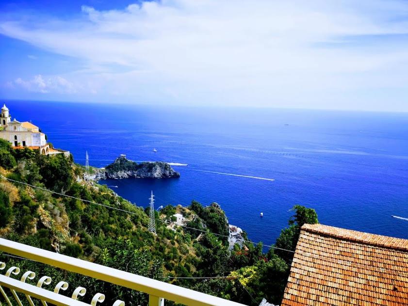 a view of the ocean from a building on a hill at Locanda Degli Agrumi in Conca dei Marini