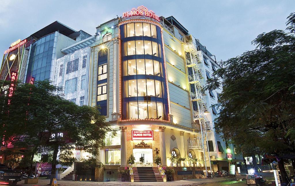 a tall building with lights on in a city at DLmos Hanoi Hotel in Hanoi