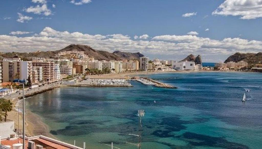 a view of a beach with buildings and the ocean at Playa Delicias in Águilas