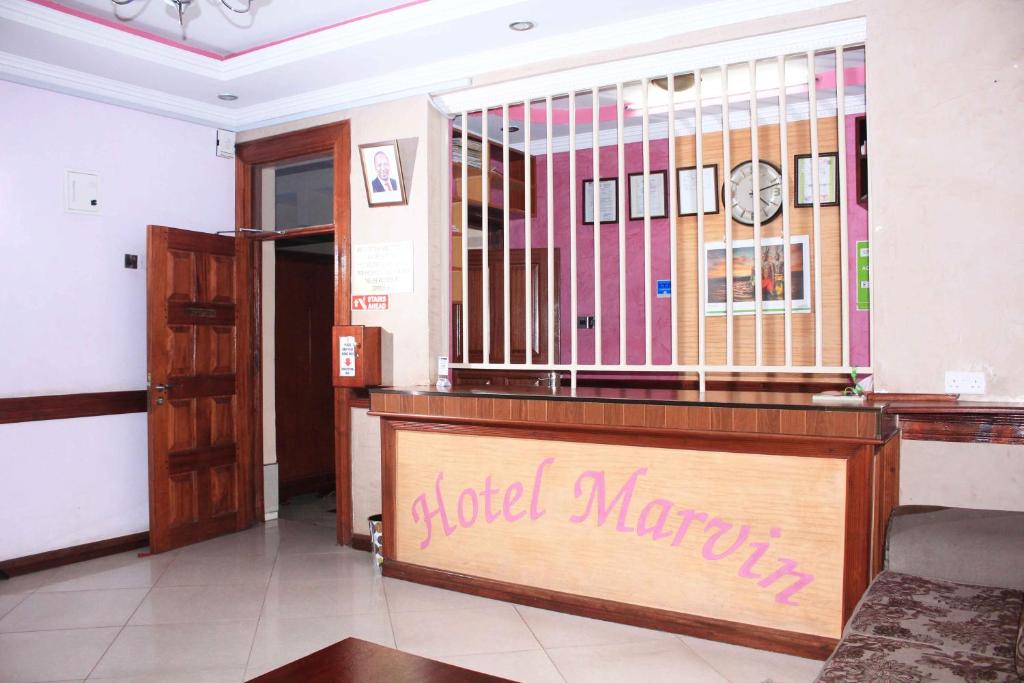 a lobby with aoked martini sign on the front of a practition at Hotel Marvin in Nakuru