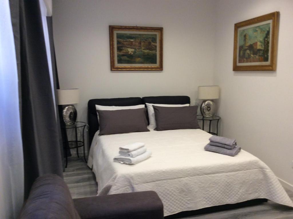 a bedroom with a bed with towels on it at Granduca in Bologna