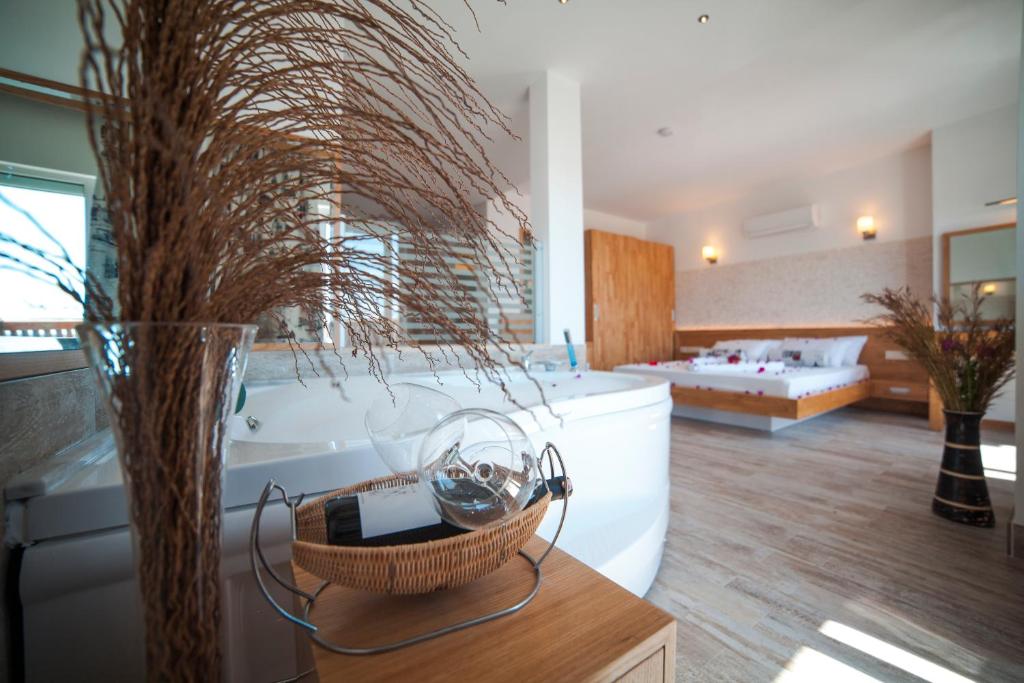 a large bathroom with a tub and a living room at Nur Hotel in Kaş