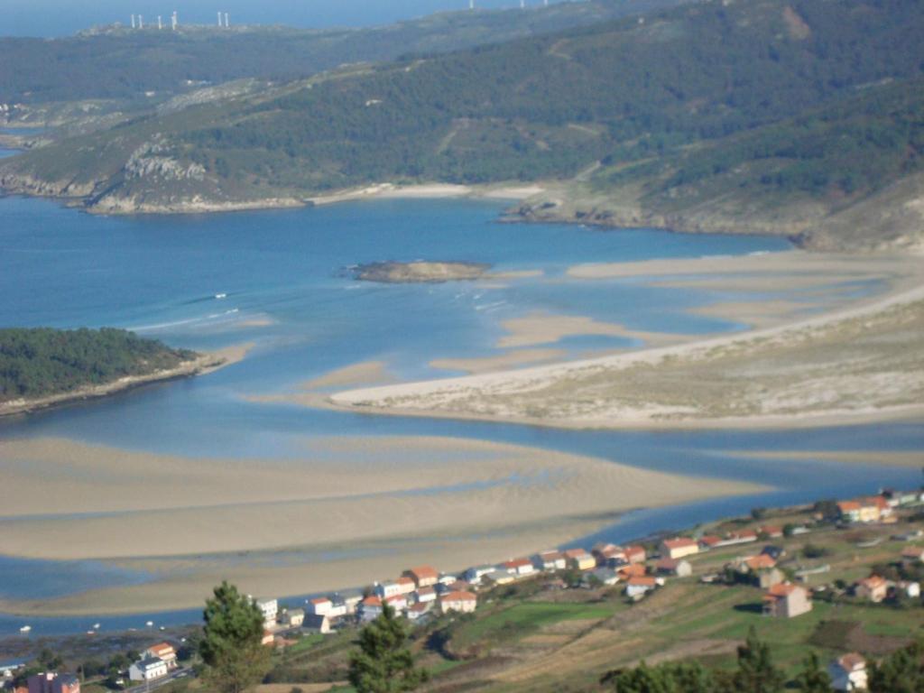 an aerial view of a lake with houses and a town at Casas Cuncheiro in Canduas