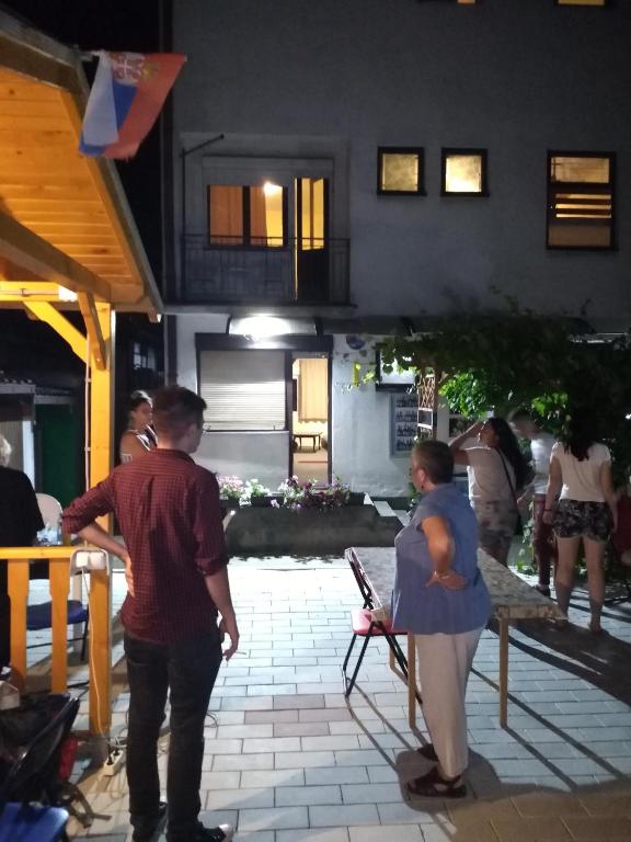 a group of people standing outside of a building at Hostel Trajan in Donji Milanovac