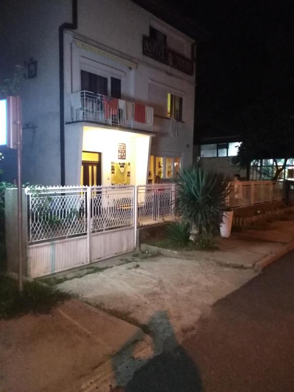 a shadow of a person standing in front of a building at Hostel Trajan in Donji Milanovac