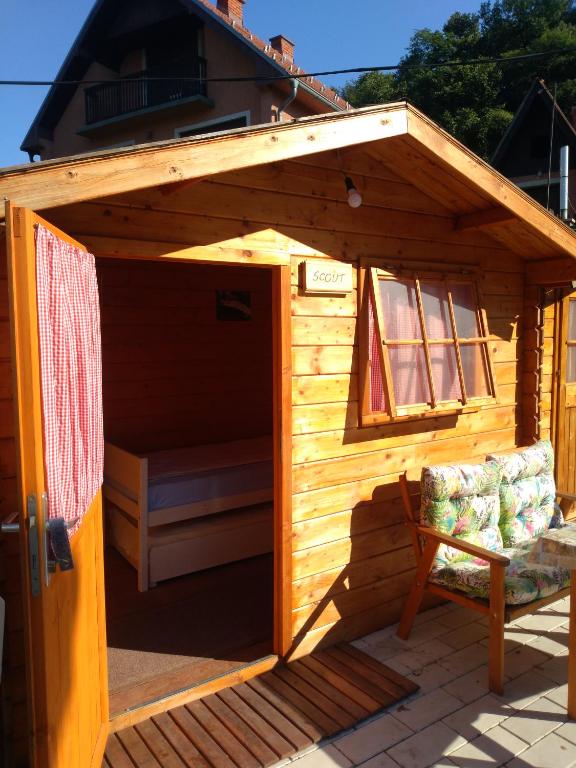 a wooden play house with a chair in it at Hostel Trajan in Donji Milanovac