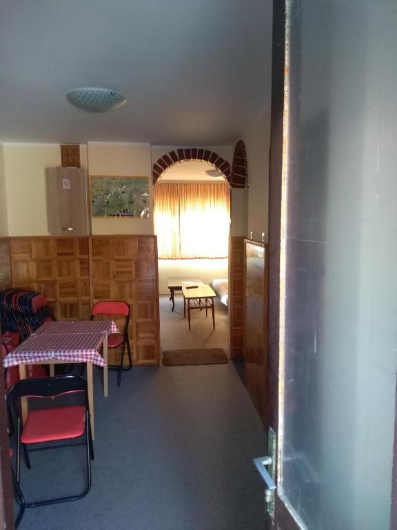 a kitchen and dining room with a table and chairs at Hostel Trajan in Donji Milanovac