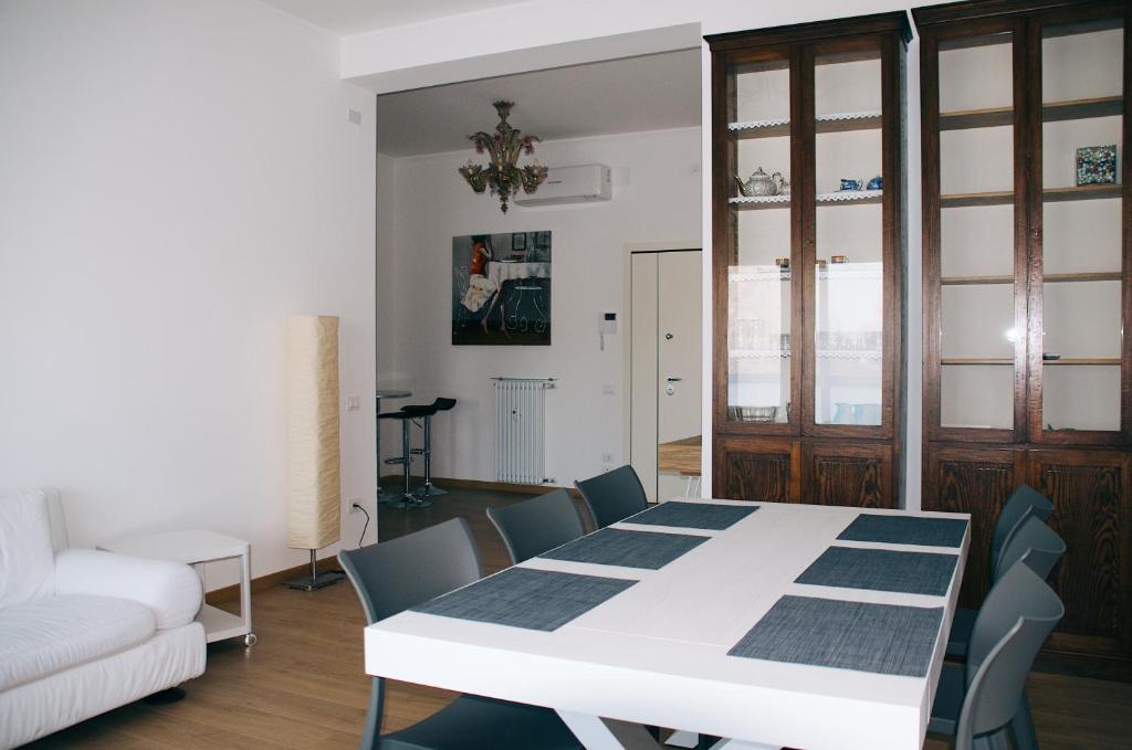 una sala da pranzo con tavolo e sedie bianchi di La Maison di Laura a Treviso
