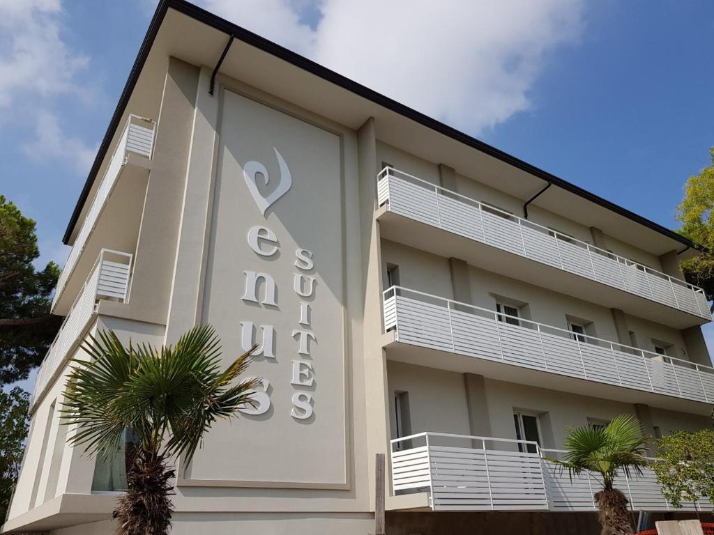 a building with a sign on the side of it at Residence Hotel Venus Suites in Cervia