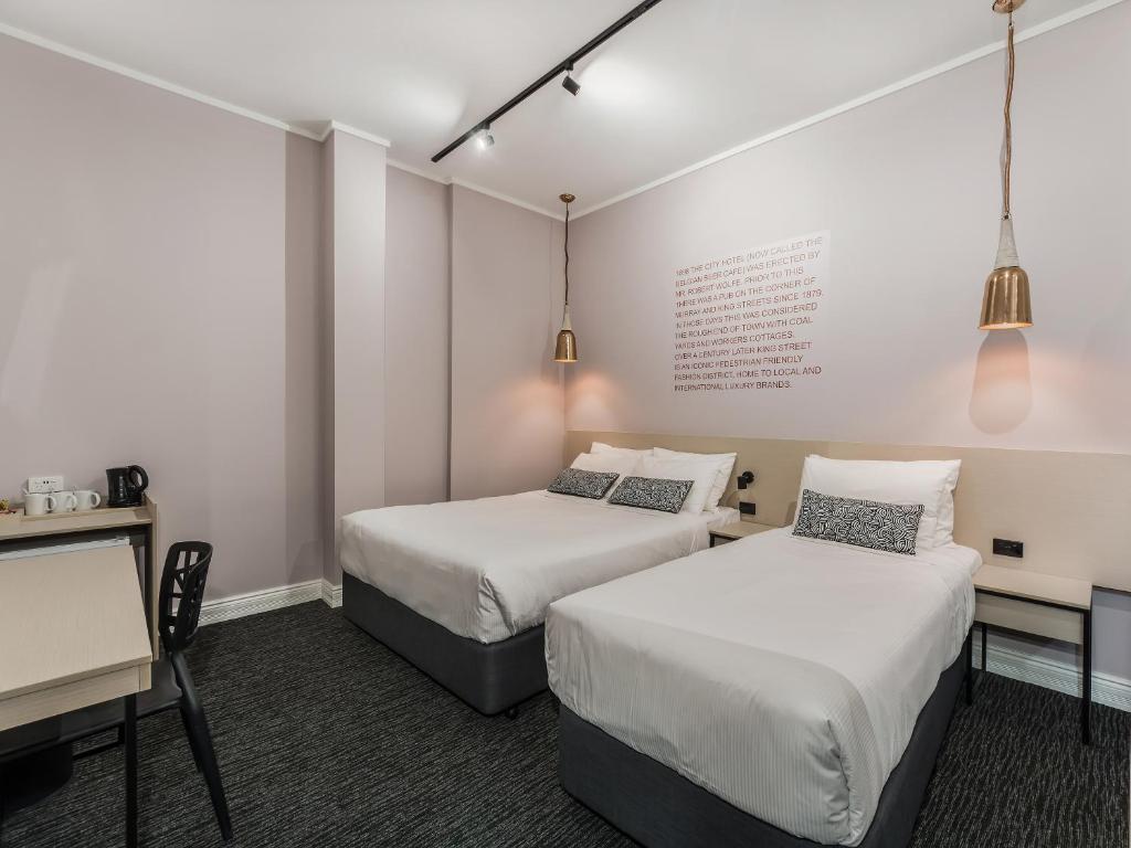 a hotel room with two beds and two lamps at Nightcap at Belgian Beer Cafe in Perth
