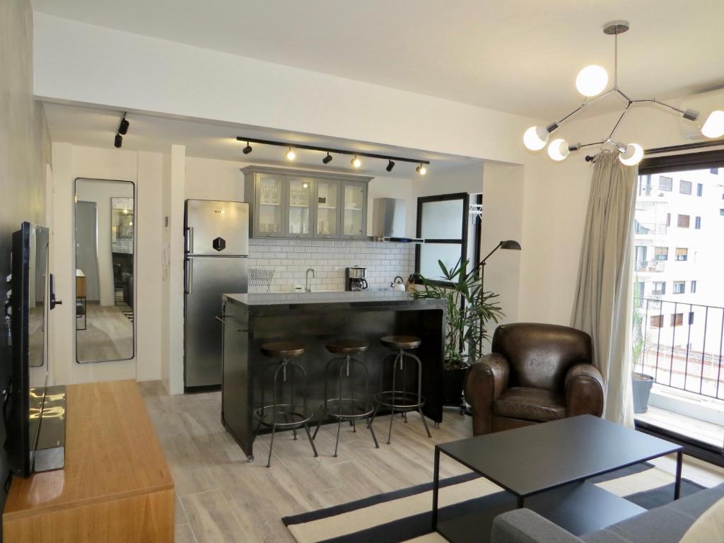 a kitchen and living room with a refrigerator and a table at Anita's Place in Buenos Aires