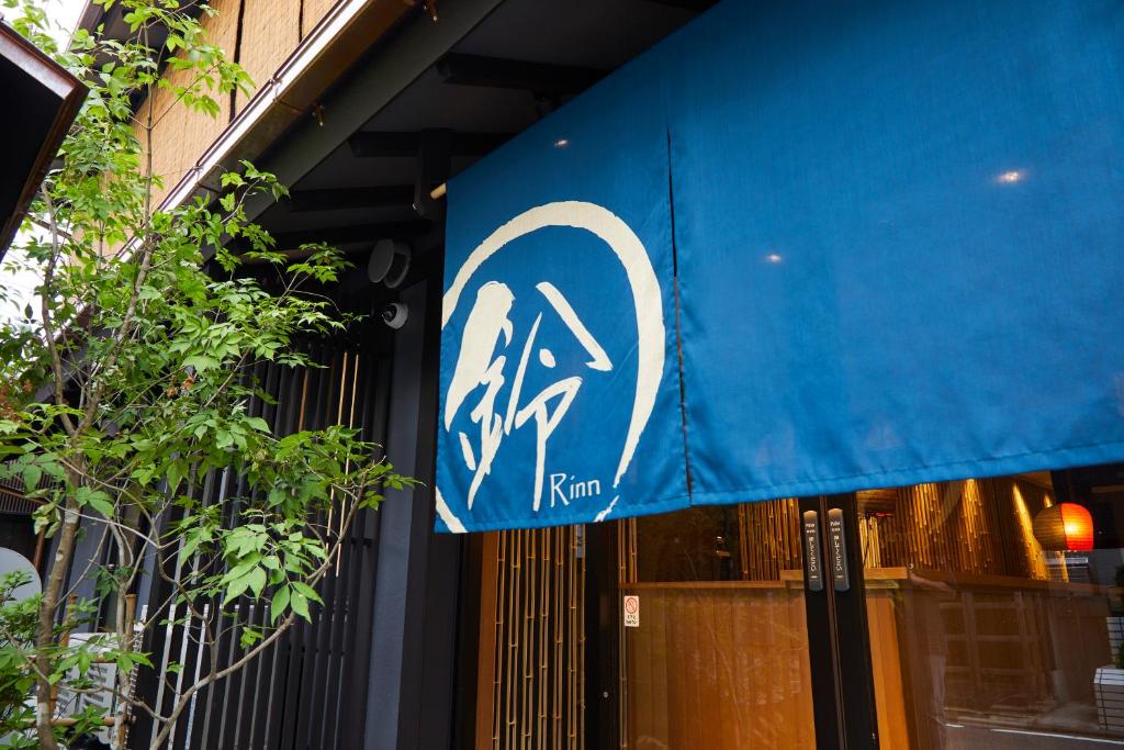 a blue and white sign on the side of a building at Rinn Gion Kenninji in Kyoto